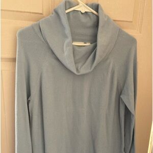 A light weight cowl neck sweater with a longer length.